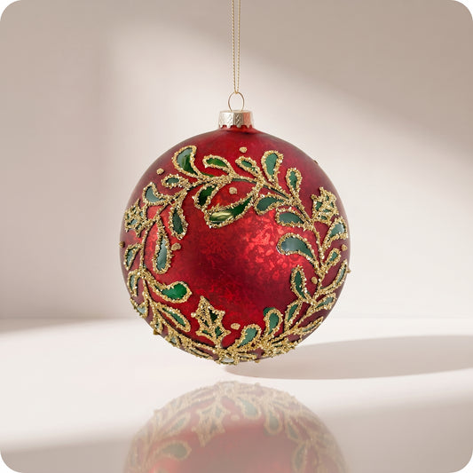 Esfera de cristal rojo con hojas verdes y brillos dorados 12 cm